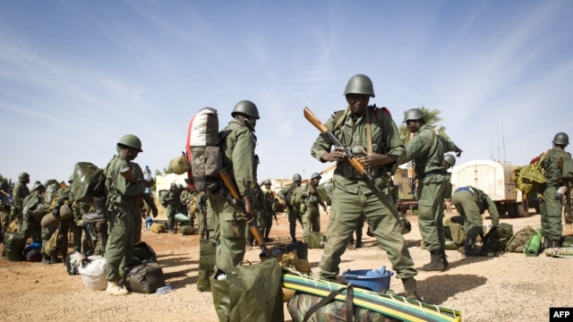 Malian soldiers line up to embark on a French Army transport bound for Gao on January 27.