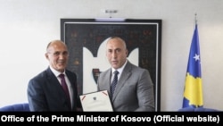 Fired Interior Minister Bejtush Gashi (left) pictured with Kosovo's prime minister in April.