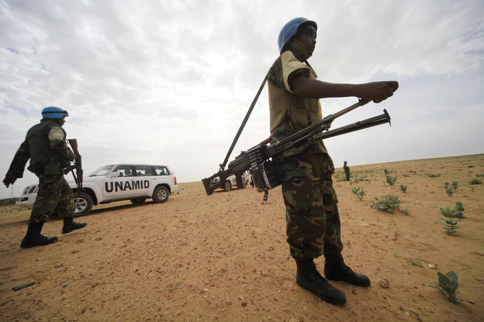 United Nations Mission in Darfur peacekeepers stand guard in Shagra village, North Darfur, October 18, 2012.