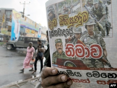 A man reads a newspaper bearing a photo of Tamil Tiger leader Velupillai Prabhakaran on the front page in Colombo on May 18.