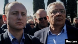Montenegrin opposition leaders Milan Knezevic (left) and Andrija Mandic wait outside parliament on February 15.