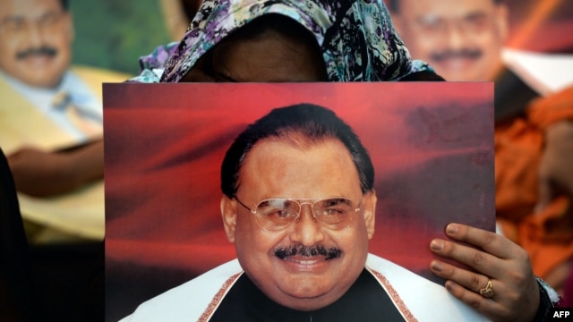 Supporters of Pakistan's Muttahida Qaumi Movement (MQM) party hold photographs of party leader Altaf Hussain as they stage a sit-in calling for his release in Karachi on June 3.