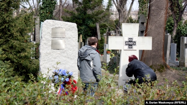 The now-removed plaque (left) is seen on March 18 next to a memorial in Prague's Olsany Cemetery that honors White Army veteran emigres who were defeated by the Bolshevik Red Army.