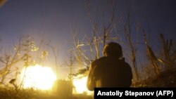 A Ukrainian serviceman shoots a machine gun during fighting with Russia-backed separatists near Avdiyivka in eastern Ukraine on November 3.