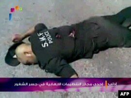 A screen grab shows what Syrian state TV said were police officers shot dead by 'armed gangs' during a massacre in the town of Jisr al-Shughour.