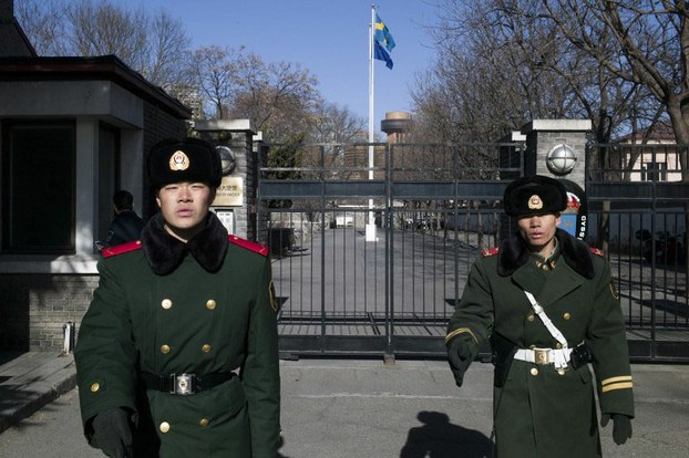 Chinese police stand guard outside the Swedish embassy in Beijing, Jan. 13, 2016.