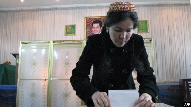 A woman casts her ballot at a polling station in Ashgabat.