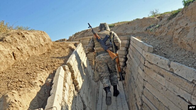 An Armenian soldier runs in trenches on the border of the disputed of Nagorno-Karabagh region. 