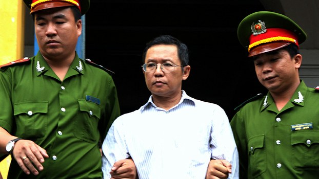 Pham Minh Hoang (C) is led out from the courtroom at the Ho Chi Minh City People's Court House after being jailed for attempted subversion, in a file photo.