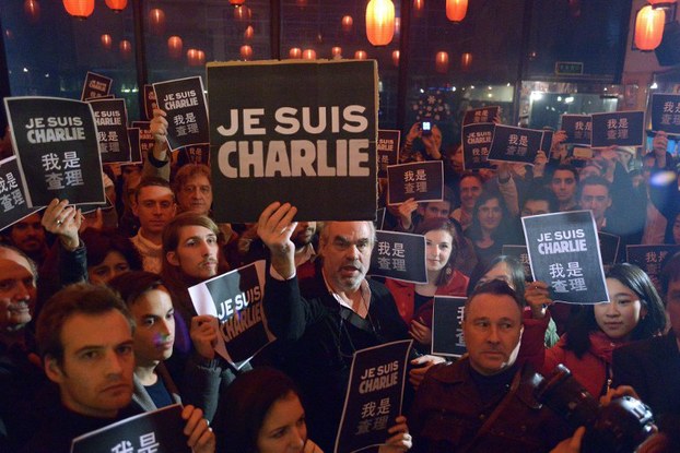 People holding banners reading 'Je Suis Charlie' (I am Charlie) take part in an event in Beijing, Jan. 8, 2015.
