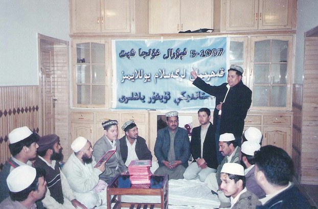 Omer Khan speaks to a group of Uyghurs in Rawalpindi, in a file photo