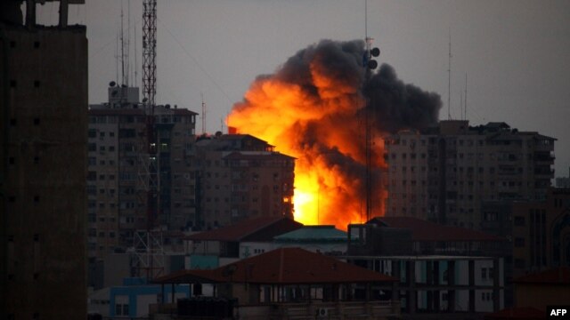A ball of fire rises from a building following an Israeli air strike in Gaza City on August 23.