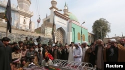 Funeral prayers for victims of an Islamic State suicide bombing of a Sufi shrine in Sindh province