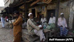 Bengali immigrants living in Pakistan gather at a market in Karachi on September 17.
