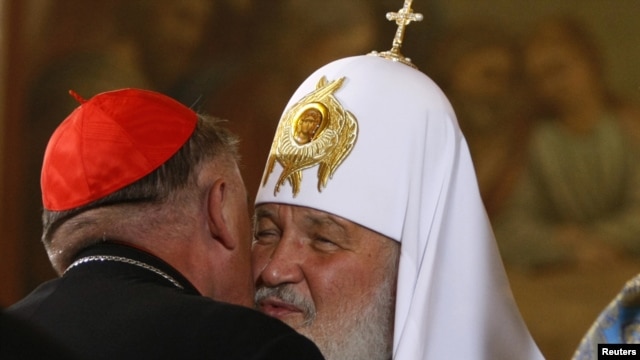 Kirill, the patriarch of Moscow and All Russia, greets Cardinal Kazimierz Nycz (left), the archbishop of Warsaw.