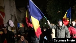 Demonstrators at a rally calling for Moldova's unification with Romania in Bucharest on October 22
