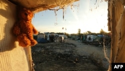 A teddy bear left behind by migrants hangs at the demolished 'Jungle' camp in Calais in northern France, late last year.