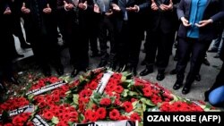 Mourners pray after laying wreaths near the site of the Reina nightclub massacre in Istanbul, which left 39 people dead.