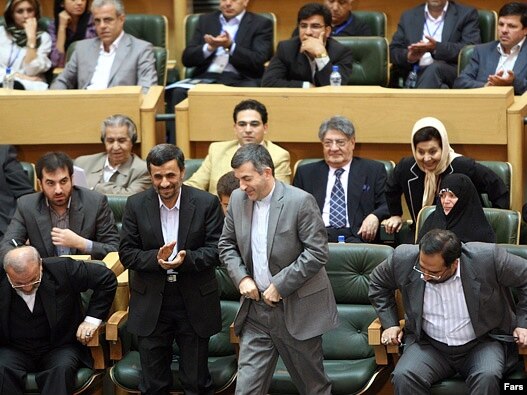 President Mahmud Ahmadinejad (left) applauds as Esfandiar Rahim Mashaei, head of his office, prepares to speak at the conference.
