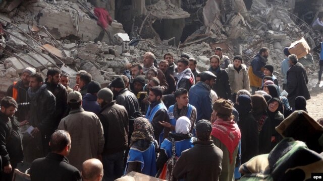 Palestinians wait for food supplies at the Palestinian Yarmouk refugee camp in January 2014.