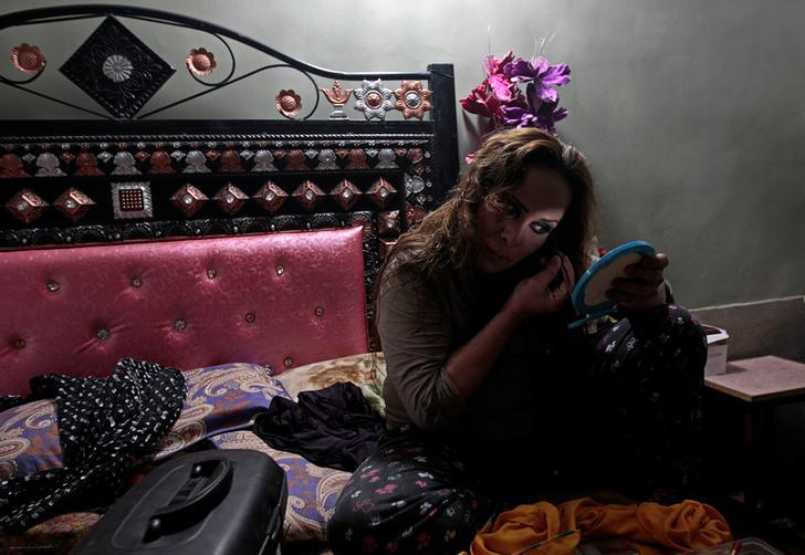 A member of the transgender community applies make up as she prepares for Shakeela's party in Peshawar, Pakistan on January 22, 2017.