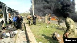 Bodies lying near burnt-out buses on Aleppo's outskirts on April 15.