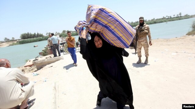 Iraqis fleeing violence in the city of Ramadi arrive at the outskirts of Baghdad in May of this year.