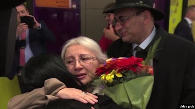 Leyla Yunus and her husband, Arif (right rear), were greeted by their daughter, Dinara Yunus