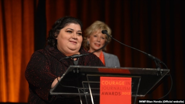 RFE/RL's Azerbaijani Service correspondent Khadija Ismayilova accepts the 2012 'Courage in Journalism' award from the International Women's Media Foundation in New York in October 2012.