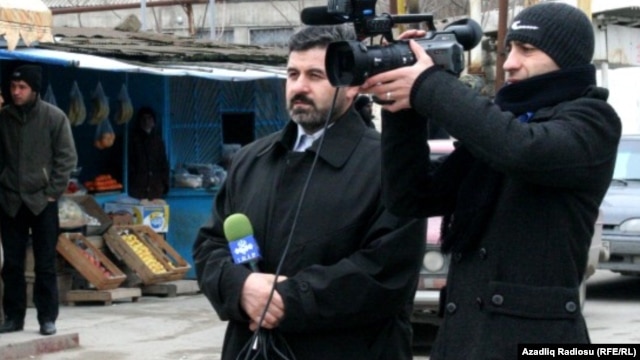 Sahar TV correspondent Anar Bayramli (left) had a year cut from his sentence.