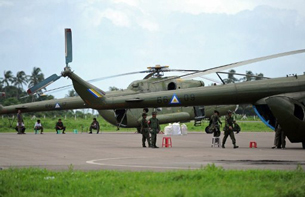 Army helicopters sit on the tarmac at the airport in Sittwe, June 12, 2012.
