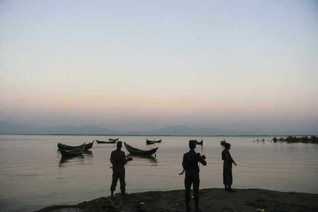 Bangladesh Border Guard personnel stand watch for illegal entry of Rohingya Muslims along the banks of the Naaf River, Nov. 23, 2016.