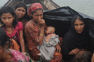 A group of Rohingya refugees fleeing violence in Burma's Rakhine state attempt to cross the Naf river into Bangladesh, June 13, 2012.