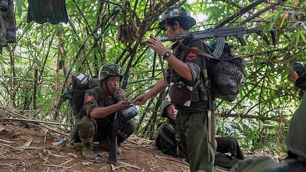 Kachin Independence Army (KIA) soldiers take a cigarette break as they move towards the frontline of fighting with the government army near Laiza in northern Myanmar's Kachin state, Oct. 14, 2016.