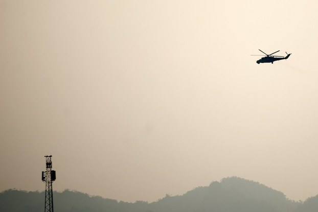 A military helicopter is seen flying in Lashio, in Myanmar's Shan state, Feb. 19, 2015.