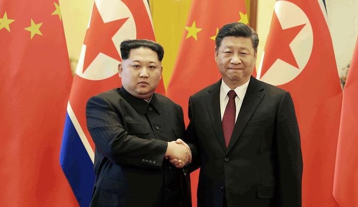 North Korean leader Kim Jong Un shakes hands with Chinese President Xi Jinping in Beijing, as he paid an unofficial visit to China, in this undated photo released by North Korea's Korean Central News Agency (KCNA) in Pyongyang March 28, 2018.