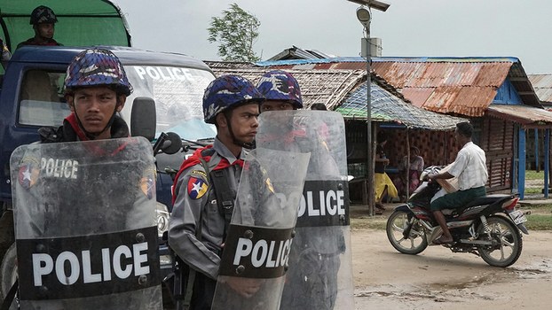 Myanmar police stand guard at an IDP camp in Sittwe, Rakhine state, September 1, 2017.