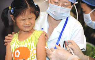 A Chinese nurse vaccinates a girl against measles in Beijing, Sept. 13, 2010.