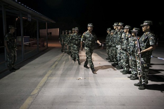 Chinese security forces at a checkpoint near the border with Myanmar in the Xishuang Banna Dai Autonomous Prefecture, Yunnan province, June 16, 2013.