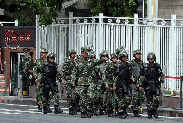 Fully armed Chinese paramilitary police patrol a street in Xinjiang's capital Urumqi, May 23, 2014.
