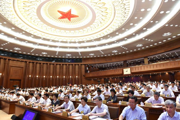 Members of China's National People's Congress Standing Committee vote during their closing meeting in Beijing, July 1, 2015.