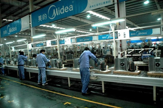 Workers labor on the production line at a Midea air conditioner plant in Wuhan, Hubei province on Feb. 4, 2009.