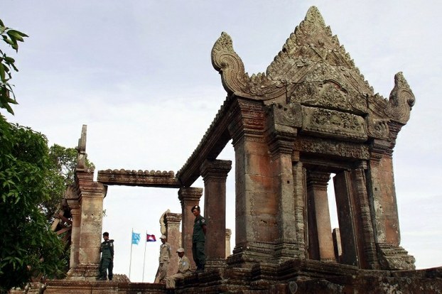 Cambodian police officials stand atop Preah Vihear temple on July 18, 2012 while Thai and Cambodian troops withdraw from disputed territory.