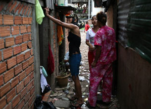 Cambodian prostitutes stand near a shelter in a Phnom Penh slum, June 10, 2008.