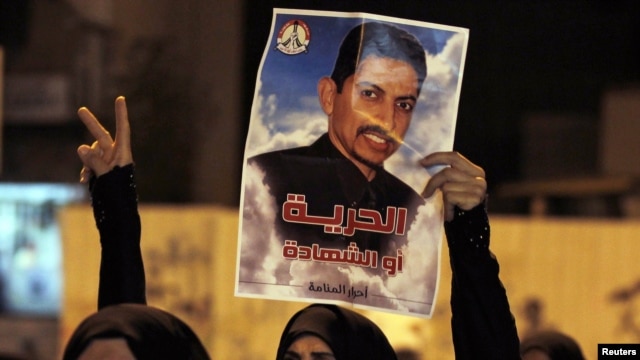 A protester holds a poster of activist Abdulhadi al-Khawaja during an antigovernment rally in Manama in April.