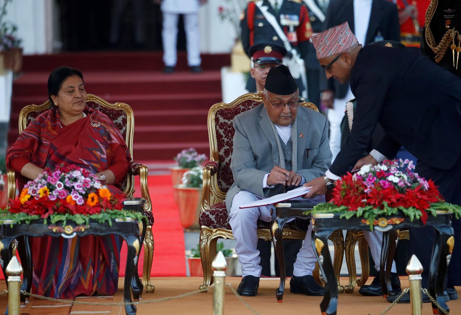 Nepal's Prime Minister Khadga Prasad Oli signs the oath of office papers next to President Bidhya Devi Bhandari in Kathmandu, Nepal, February 15, 2018.