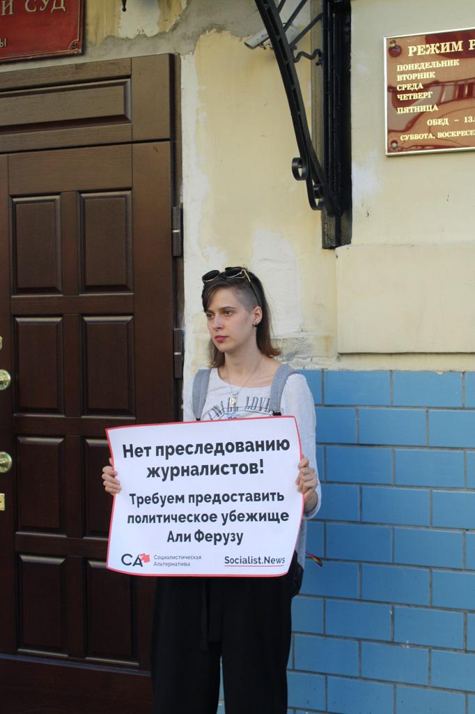 Activist outside Moscow's Basmanny District court on August 1, 2017 holds a poster declaring 