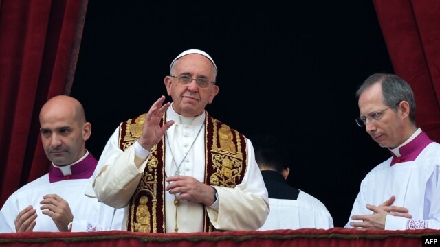 Pope Francis (center) gives his traditional Christmas 'Urbi et Orbi' blessing from the balcony of St. Peter's Basilica at the Vatican on December 25.