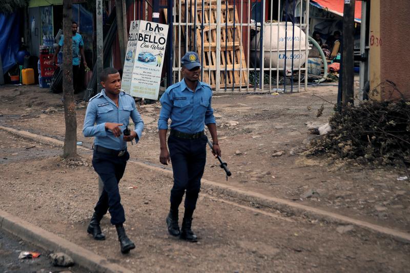 Police officers patrol along a road in Addis Ababa, Ethiopia, February 21, 2018.