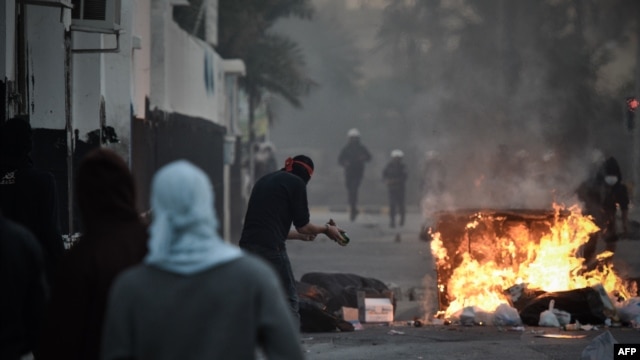 Shi'ite Bahraini protesters clash with security forces following a rally to mark the second anniversary of an uprising in the Sunni-ruled kingdom on February 14.